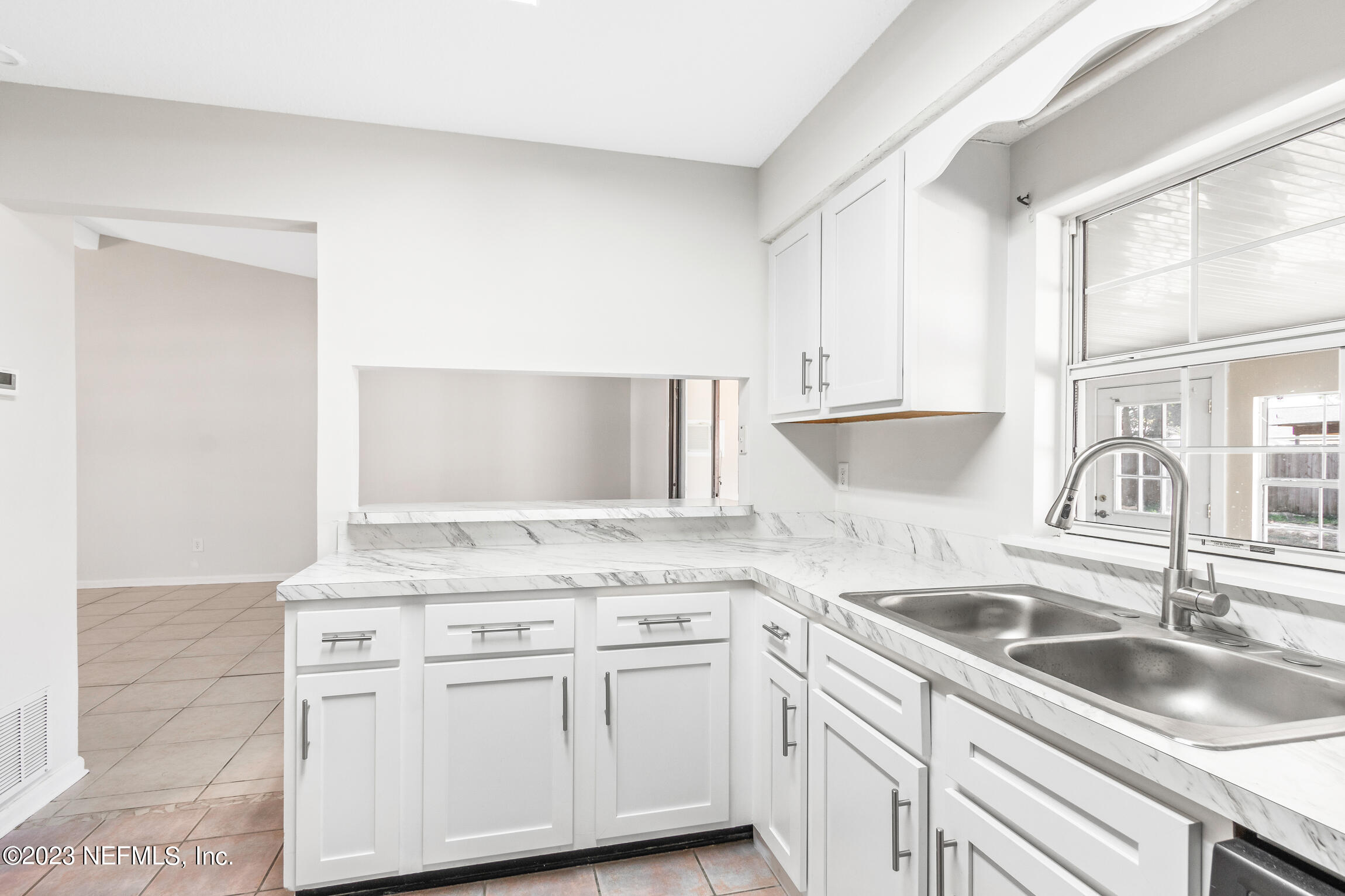 12770 Attrill Road Jacksonville, FL 32258 - Photo 26 of 38 a kitchen with granite countertop a sink and cabinets