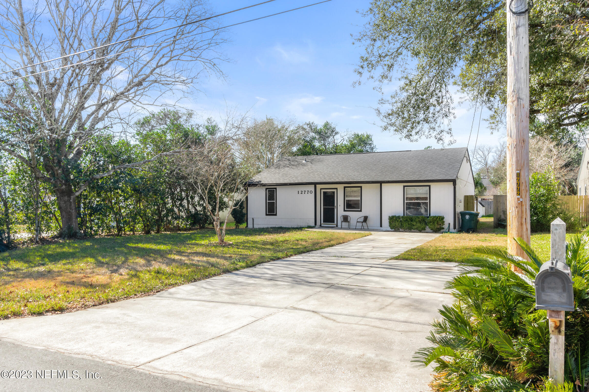 12770 Attrill Road Jacksonville, FL 32258 - Photo 3 of 38 a view of a house with a yard and large trees