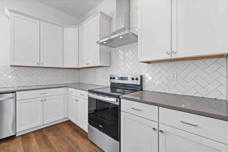 489 Hammons Way Southeast Atlanta, GA 30315 - Photo 9 of 47 a kitchen with granite countertop white cabinets and a stove