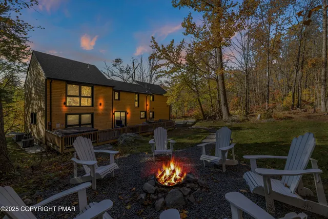 a view of a chairs and table in backyard