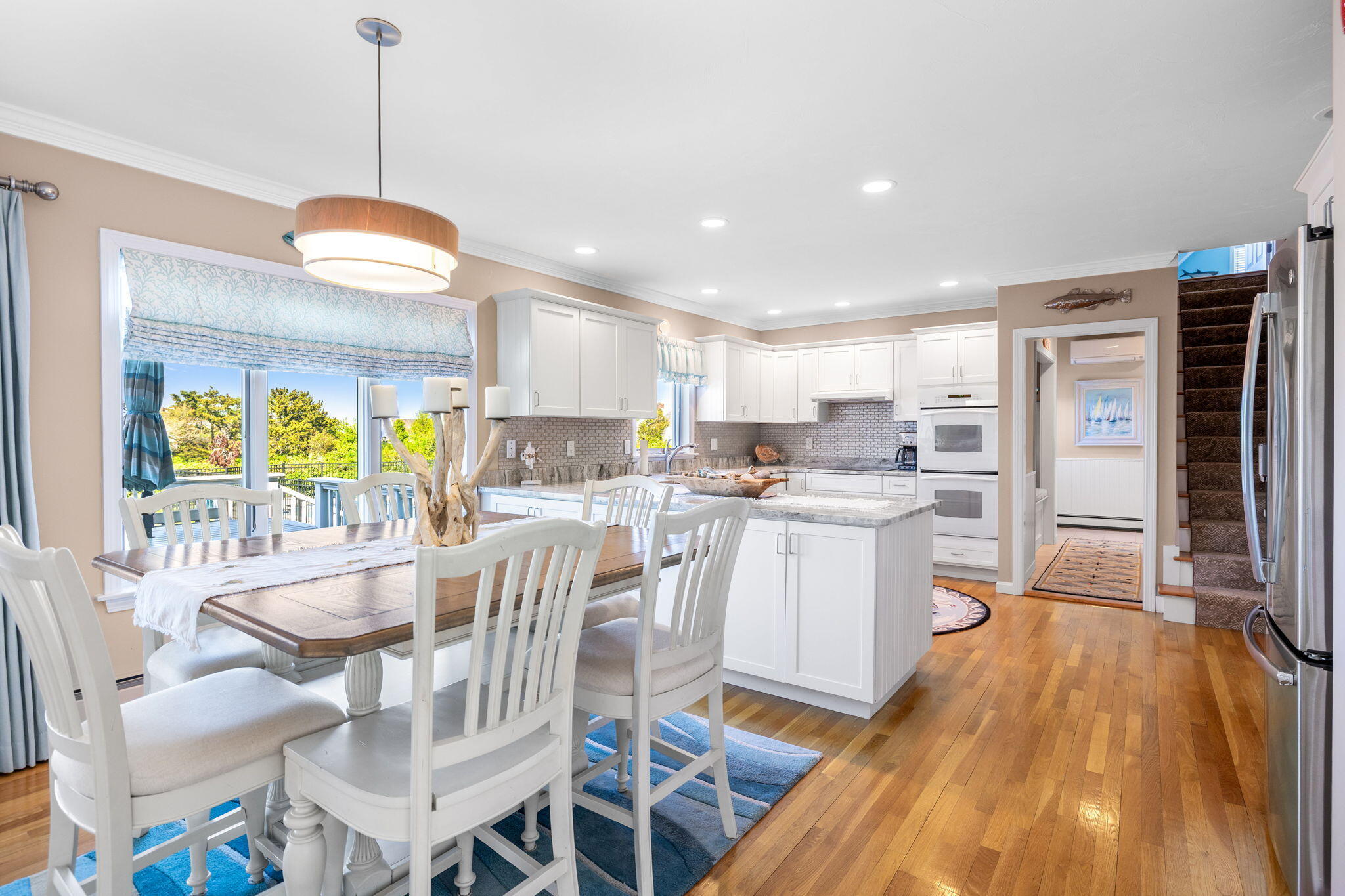 33 Torrey Road East Sandwich, MA 02537 - Photo 13 of 39 a kitchen with stainless steel appliances granite countertop a stove top oven a refrigerator a sink and a dining table with wooden floor