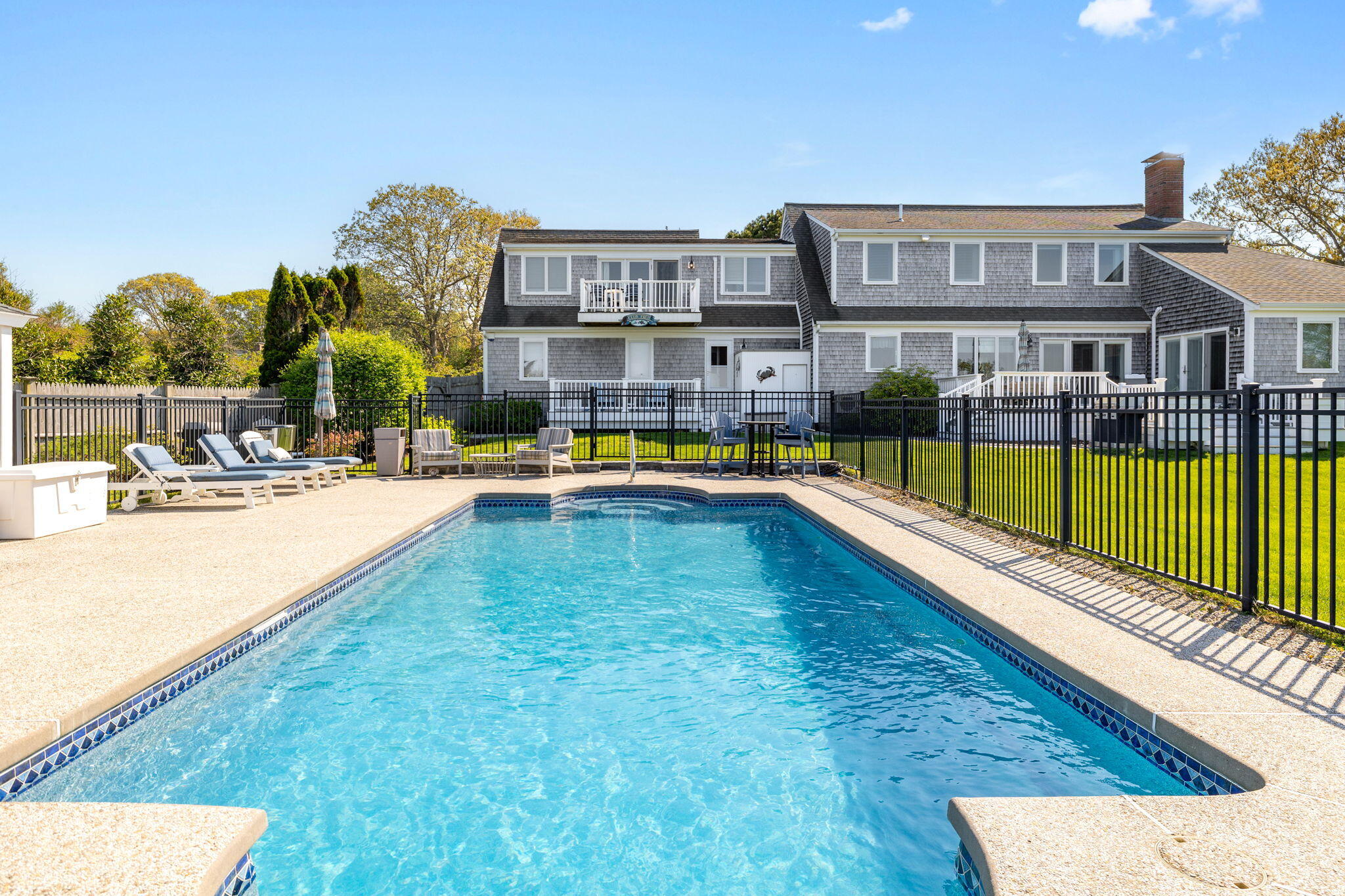 33 Torrey Road East Sandwich, MA 02537 - Photo 30 of 39 a view of a swimming pool with a lawn chairs and plants