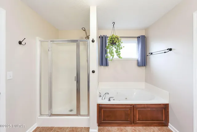 a bathroom with a bathtub and a window