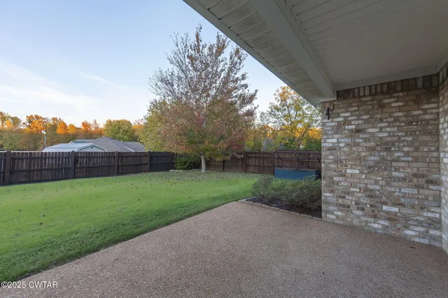 a view of a yard with large trees
