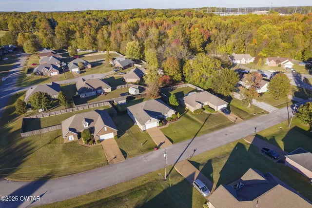 an aerial view of residential houses with outdoor space