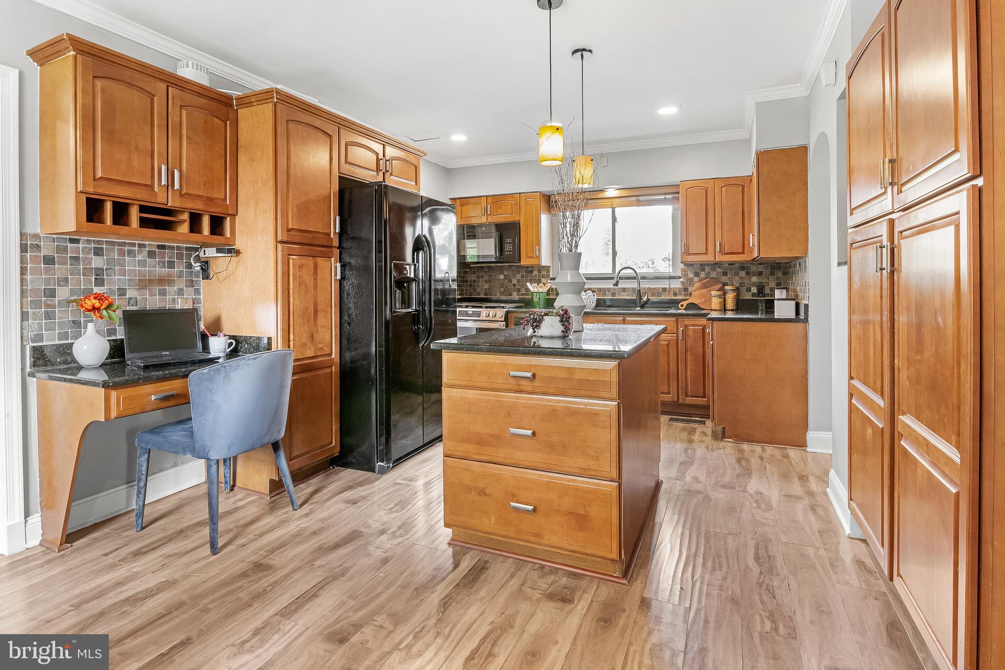 3302 Northbrook Road Pikesville, MD 21208 - Photo 13 of 45 a kitchen with stainless steel appliances granite countertop a refrigerator a stove and a wooden floors