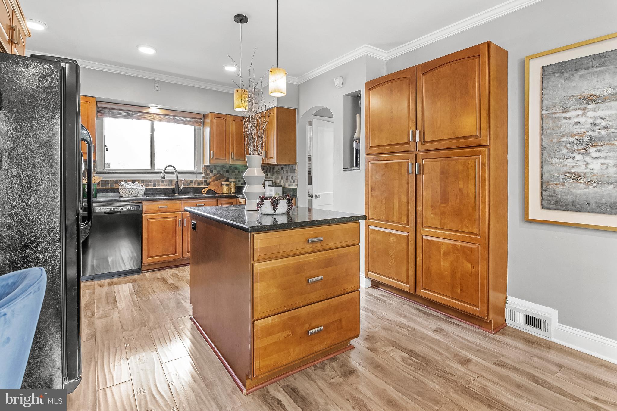 3302 Northbrook Road Pikesville, MD 21208 - Photo 14 of 45 a kitchen with kitchen island granite countertop wooden floors granite counter tops and a view of living room