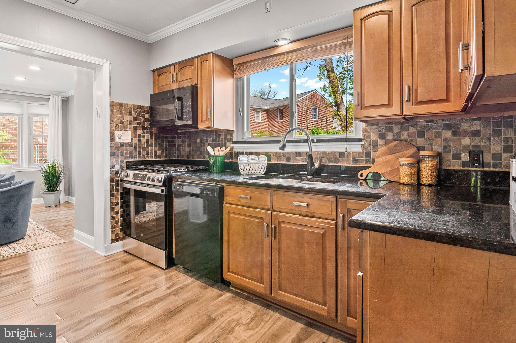 3302 Northbrook Road Pikesville, MD 21208 - Photo 17 of 45 a kitchen with stainless steel appliances granite countertop a stove a sink and a microwave