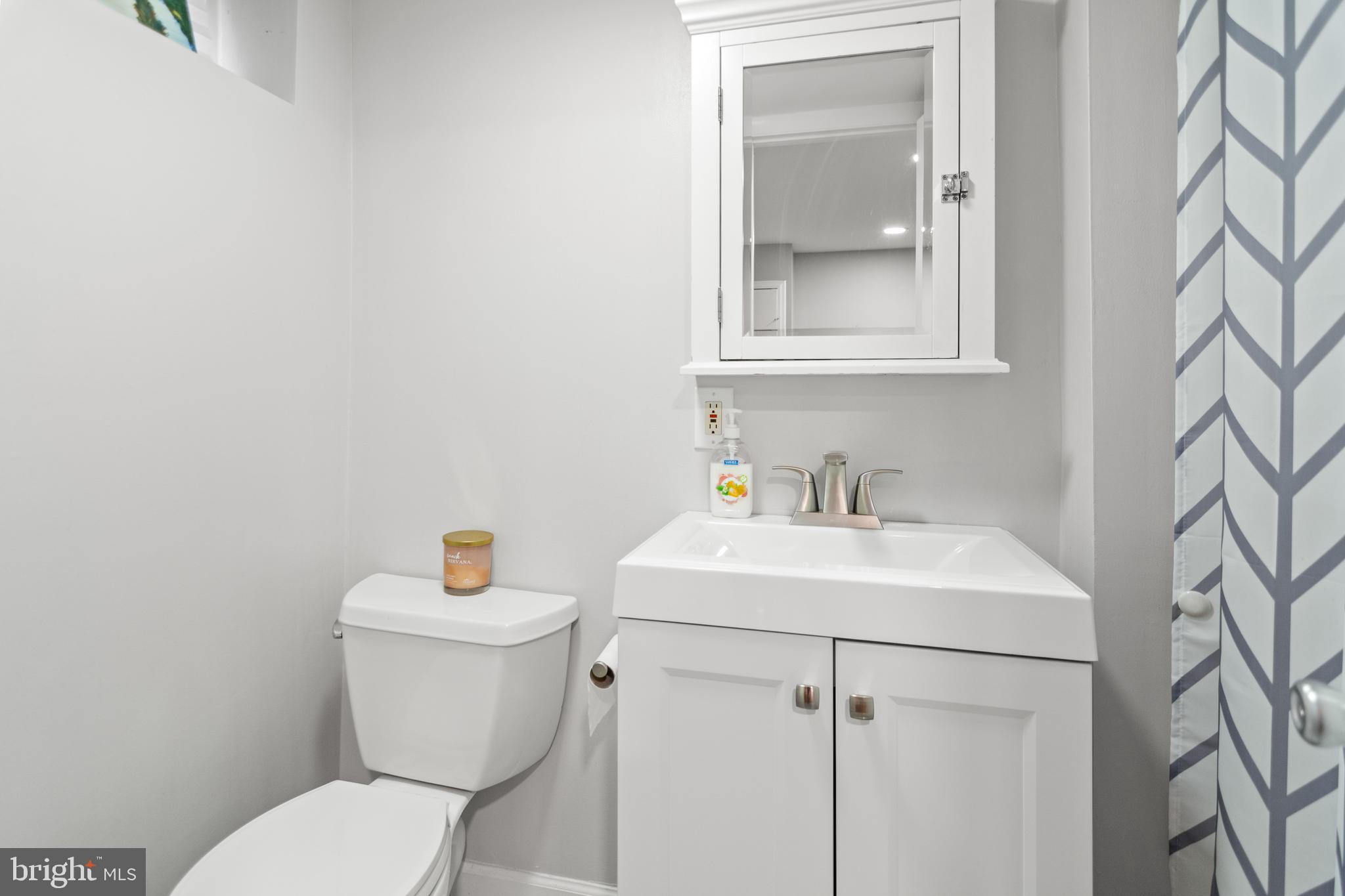 3302 Northbrook Road Pikesville, MD 21208 - Photo 34 of 45 a white toilet sitting next to a bathroom sink