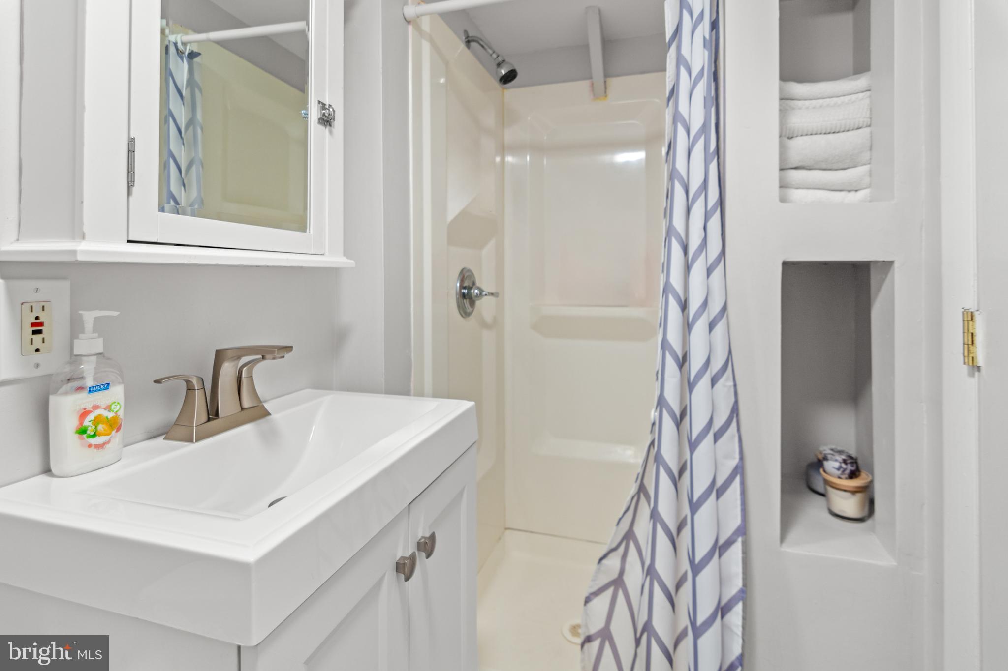 3302 Northbrook Road Pikesville, MD 21208 - Photo 35 of 45 a bathroom with a sink a vanity and a mirror