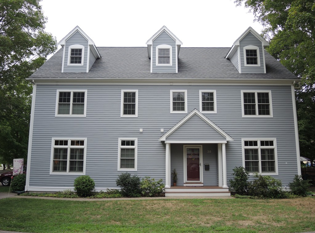 38 Maple Street, Unit 2 Needham, MA 02492 - Photo 1 of 26 a front view of a house with a yard