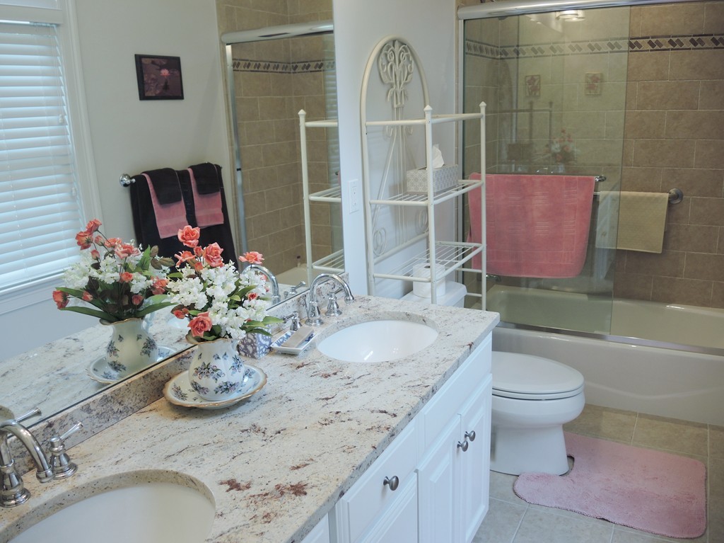 38 Maple Street, Unit 2 Needham, MA 02492 - Photo 12 of 26 a bathroom with a granite countertop sink a toilet and a mirror