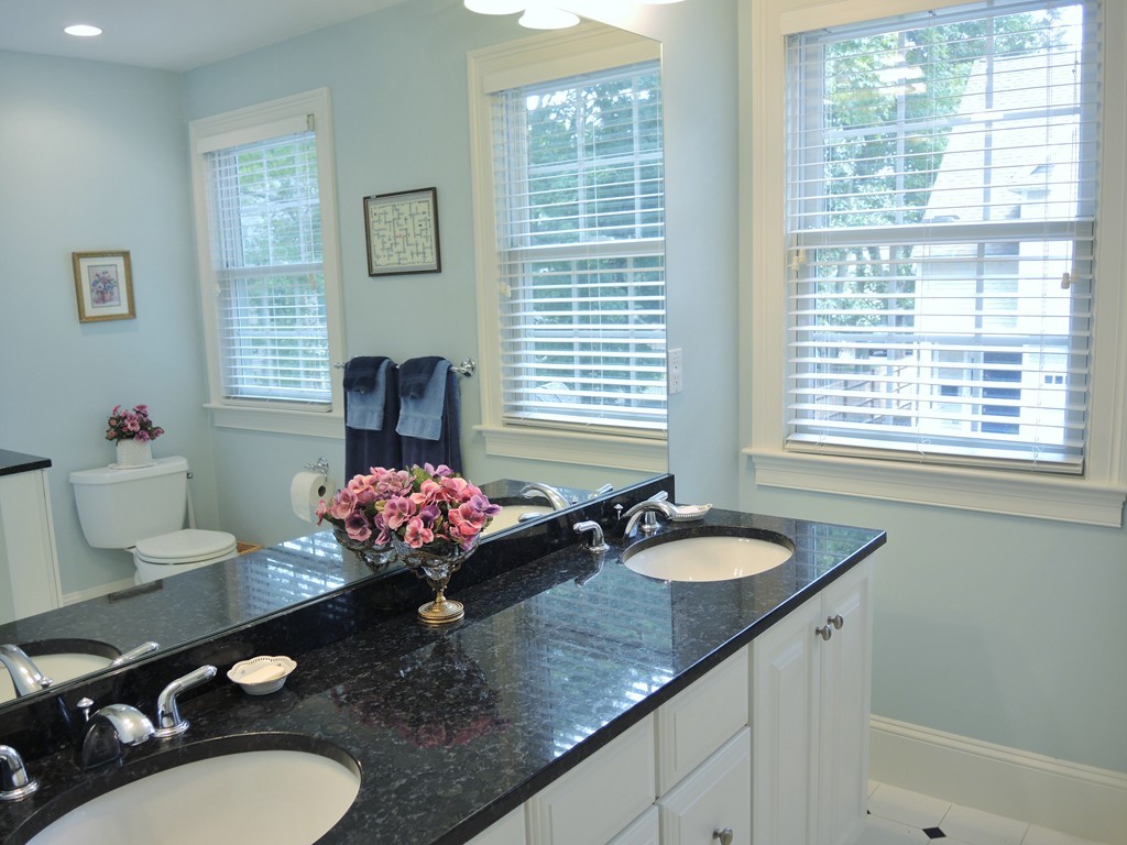 38 Maple Street, Unit 2 Needham, MA 02492 - Photo 17 of 26 a bathroom with a granite countertop sink a large mirror and a window