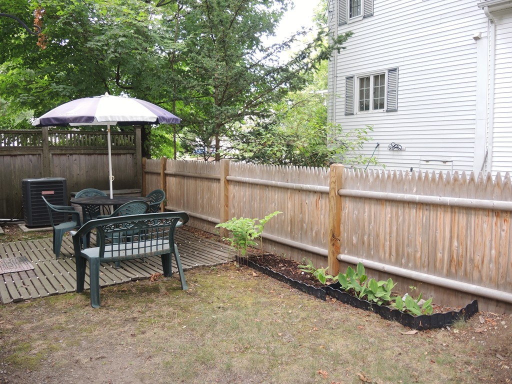 38 Maple Street, Unit 2 Needham, MA 02492 - Photo 2 of 26 a garden view with a seating space