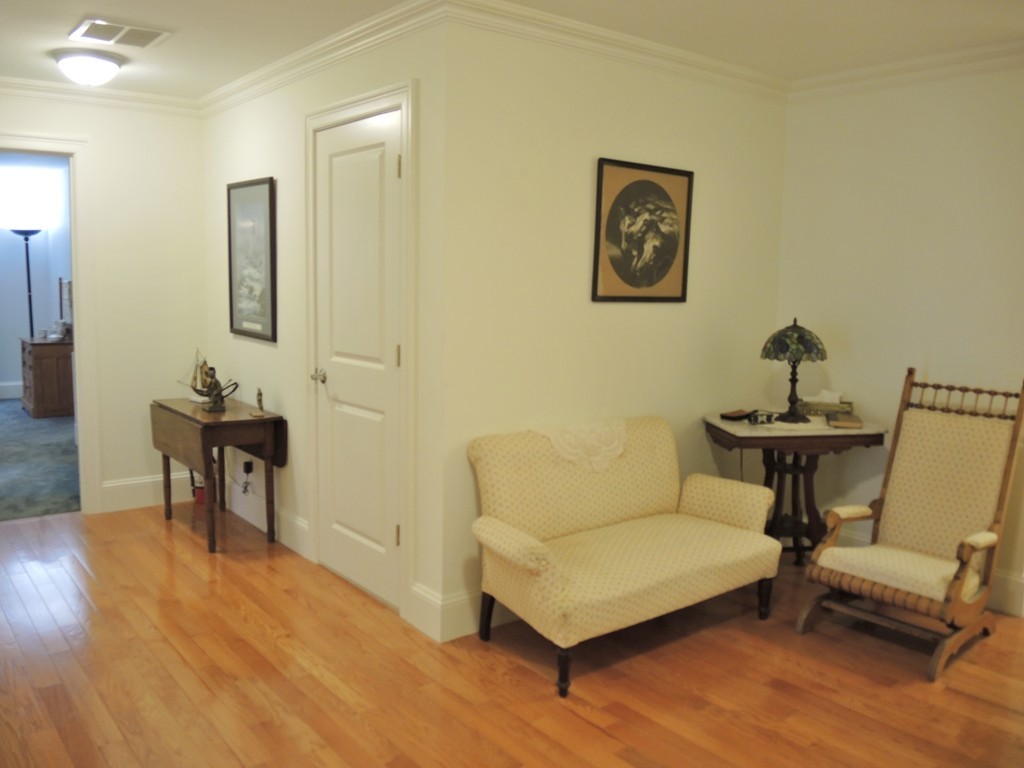38 Maple Street, Unit 2 Needham, MA 02492 - Photo 23 of 26 a living room with furniture and a wooden floor