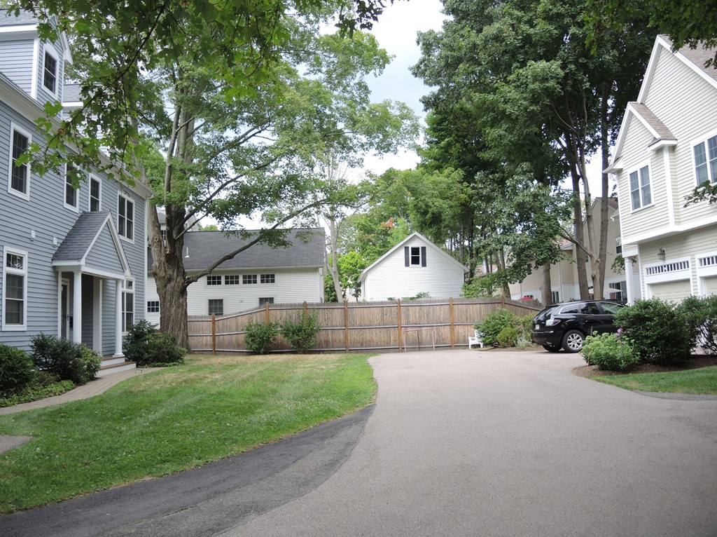 38 Maple Street, Unit 2 Needham, MA 02492 - Photo 25 of 26 a view of a house with a big yard and large trees