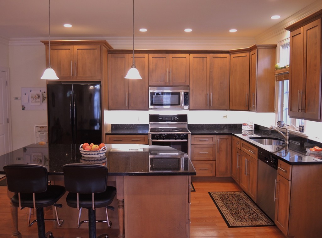 38 Maple Street, Unit 2 Needham, MA 02492 - Photo 7 of 26 a kitchen with stainless steel appliances granite countertop a stove refrigerator and a sink