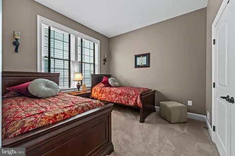 a bedroom with bed and wooden floor