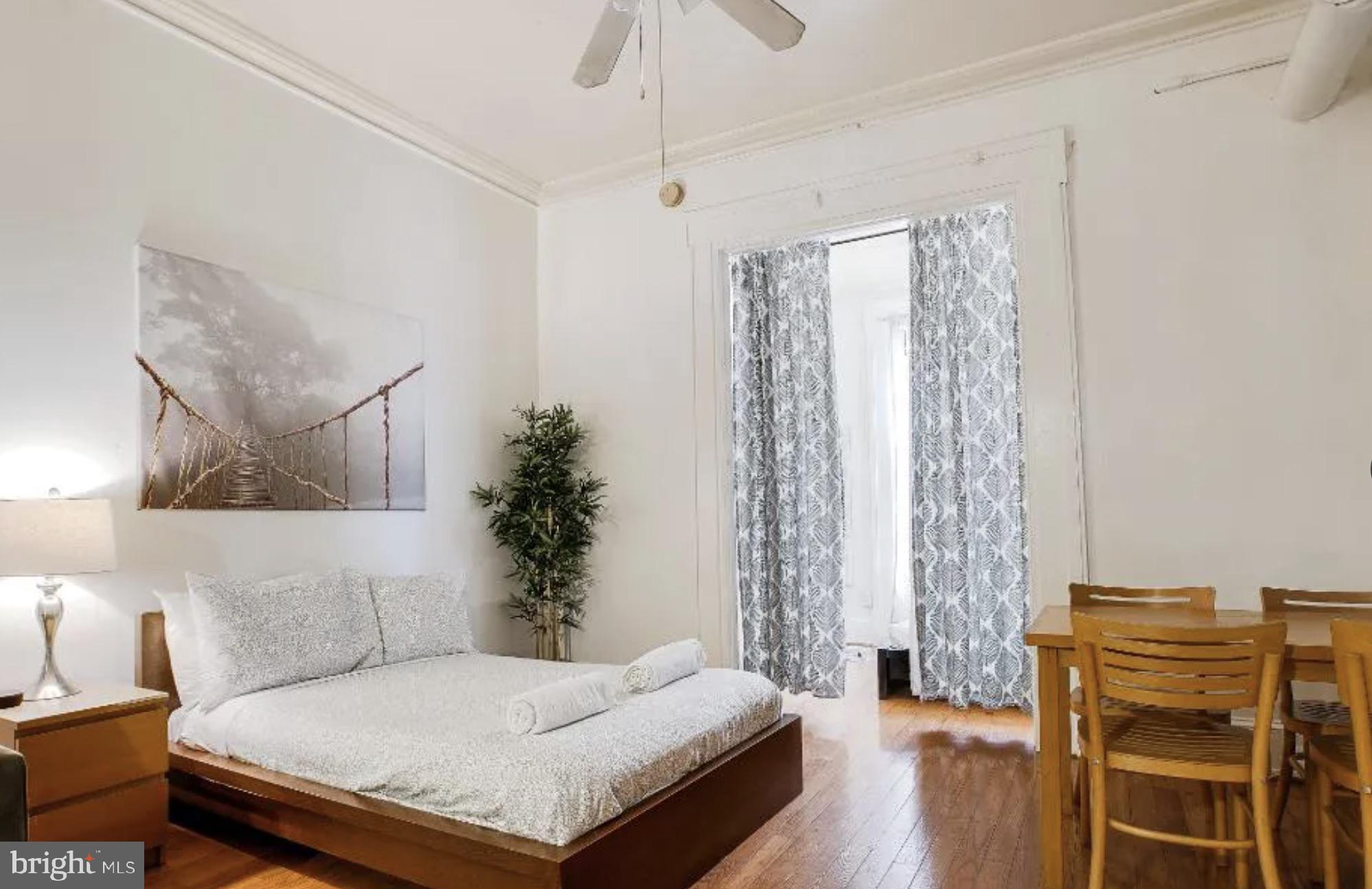 1837 Chestnut Street Philadelphia, PA 19103 - Photo 1 of 7 a bedroom with a bed and a chandelier