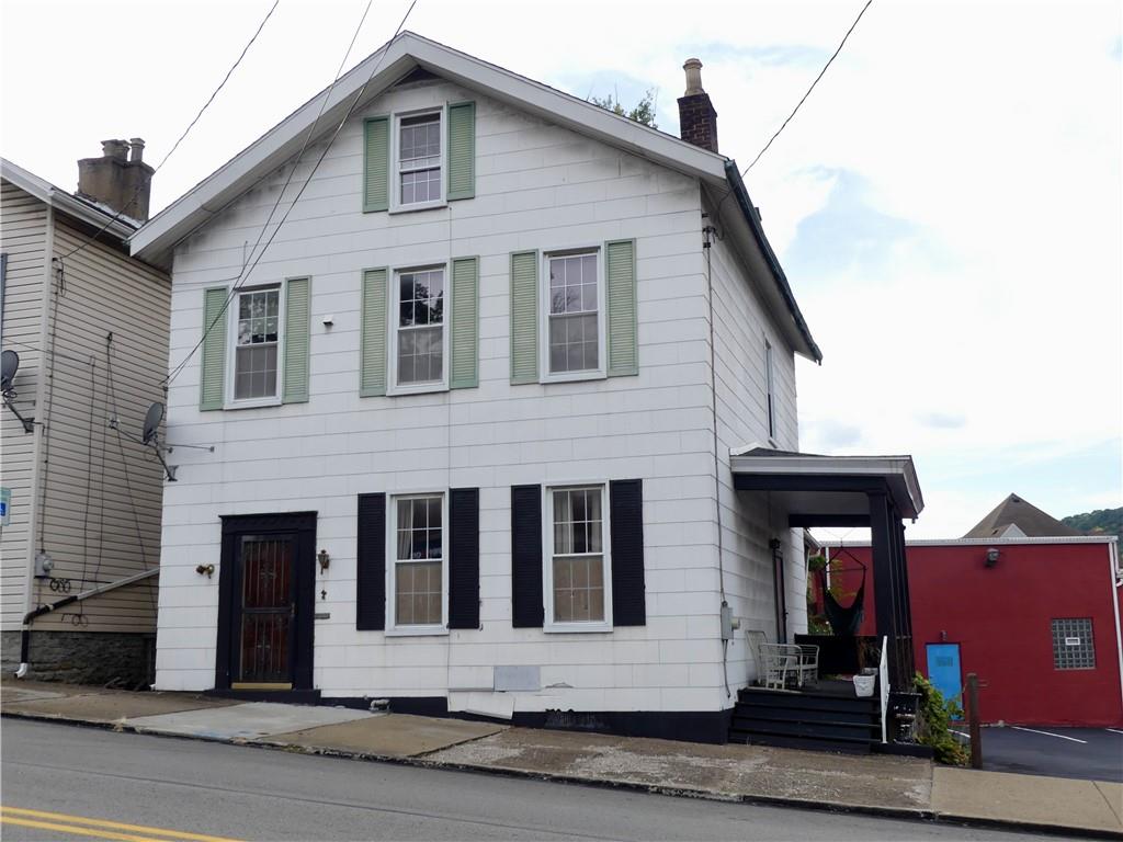 a front view of a house with garage