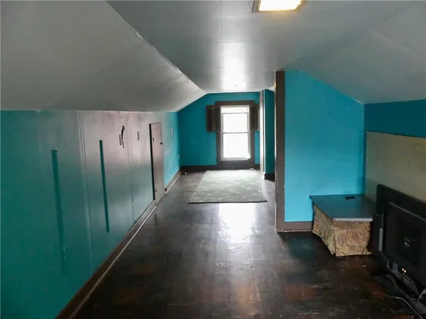 a view of hallway with stairs and wooden floor