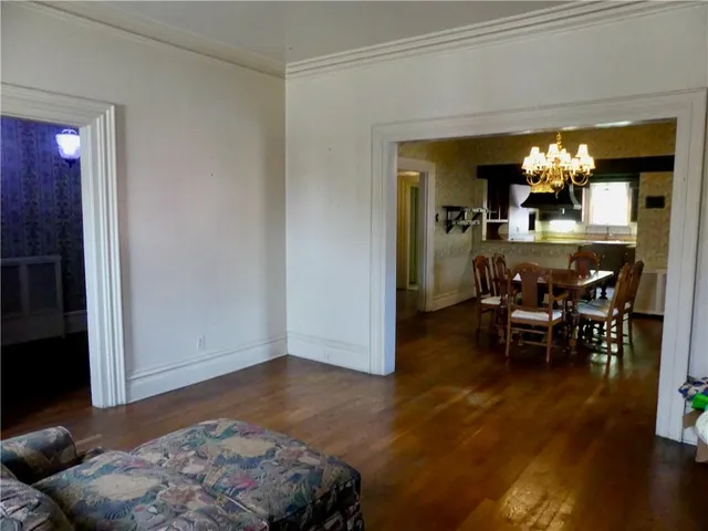 a living room with furniture and a dining room