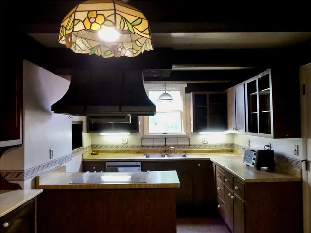 a kitchen with a sink and a stove