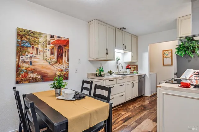 a kitchen with white cabinets and stove