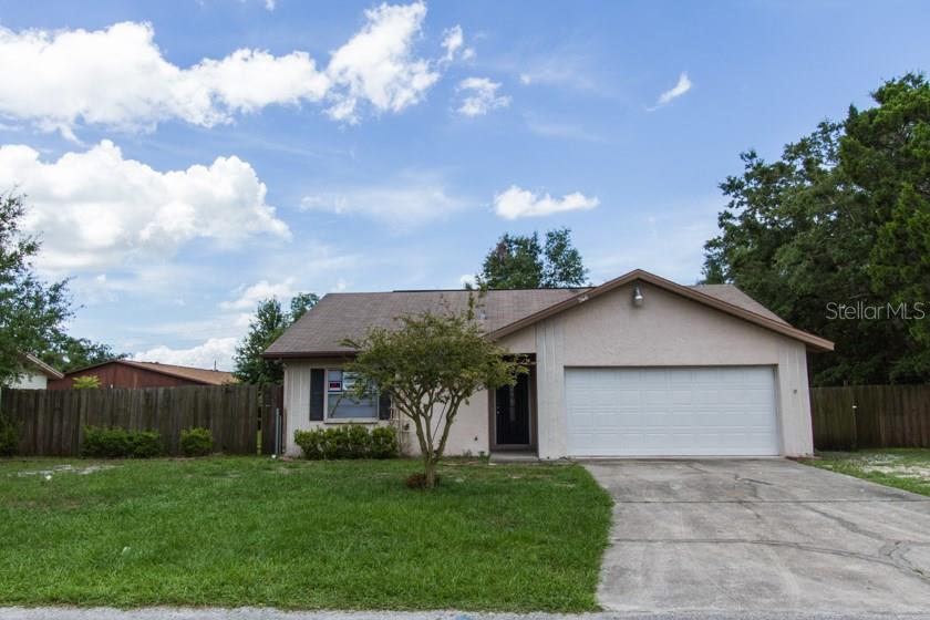 360 Holly Ridge Road Winter Haven, FL 33880 - Photo 1 of 1 a front view of a house with a yard and garage