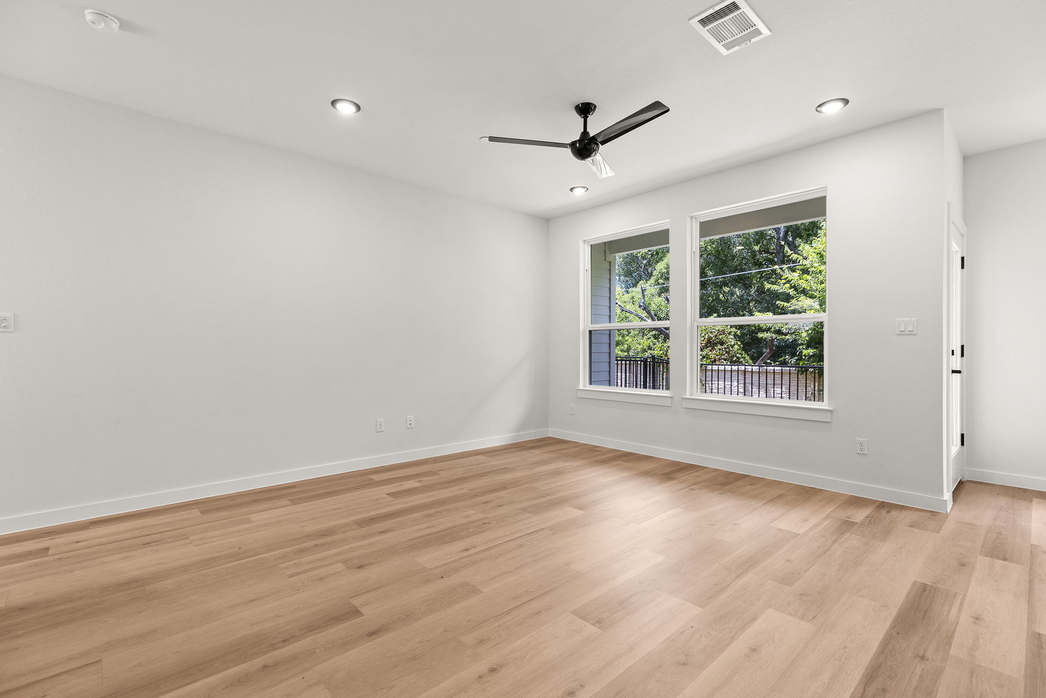 2600 Gattis School Road, Unit 1002 Round Rock, TX 78664 - Photo 13 of 40 Blonde wood flooring and two large windows brighten this versatile living space.