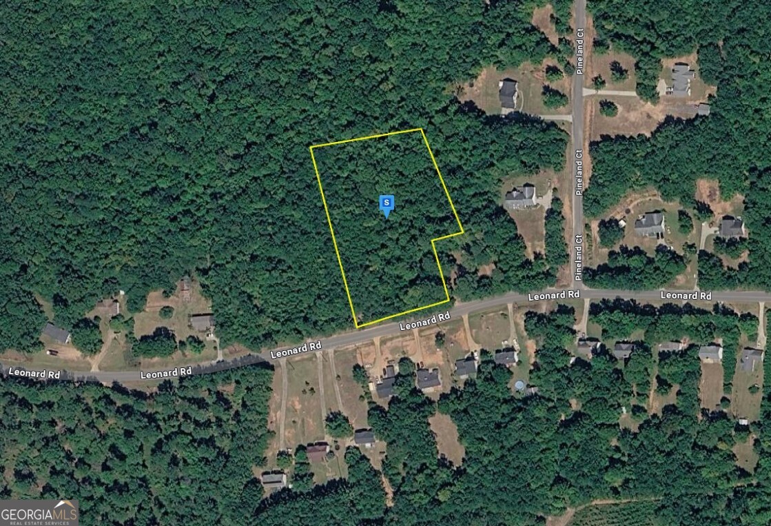 609 Leonard Road LaGrange, GA 30241 - Photo 1 of 6 an aerial view of a house with a yard and trees in the back