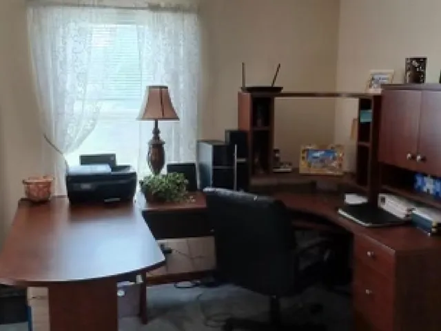 a bedroom with a bed and a lamp