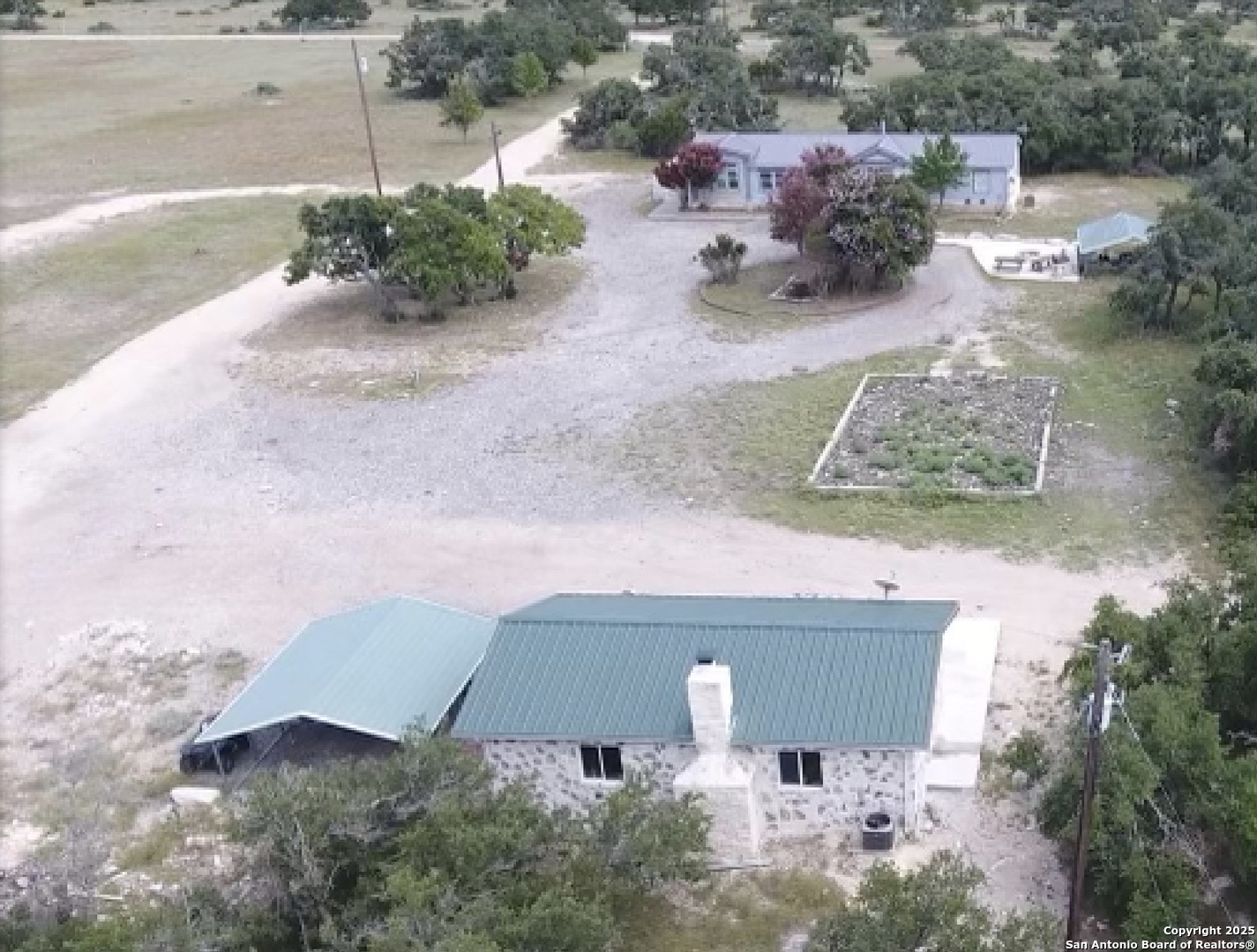 988 Sd 71600 Rocksprings, TX 78880 - Photo 2 of 25 an aerial view of a house with yard and parking