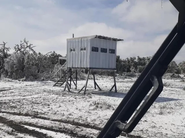 a view of balcony with wooden floor and fence