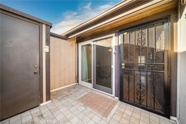 an aerial view of a house with swimming pool and outdoor seating