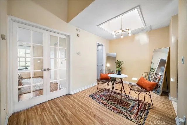 a living room with furniture a dining table and wooden floor