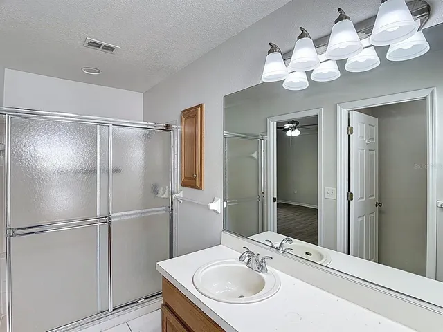 a bathroom with a sink vanity and a mirror