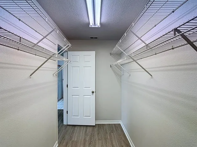 a view of a room with wooden floor