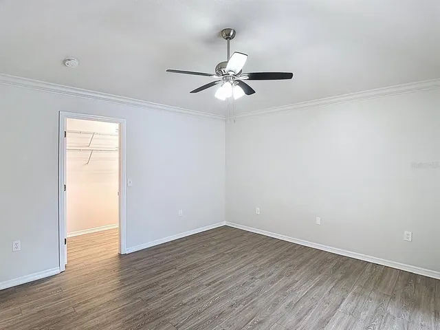 a view of empty room with wooden floor