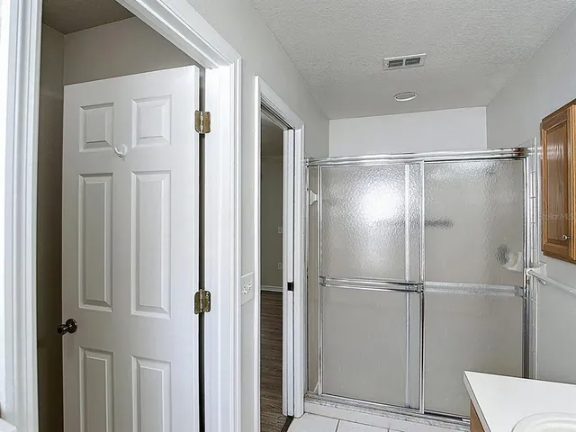a bathroom with a glass shower door