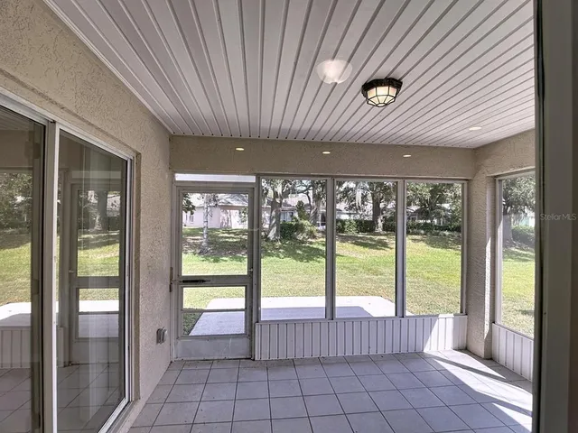 a view of an empty room with windows