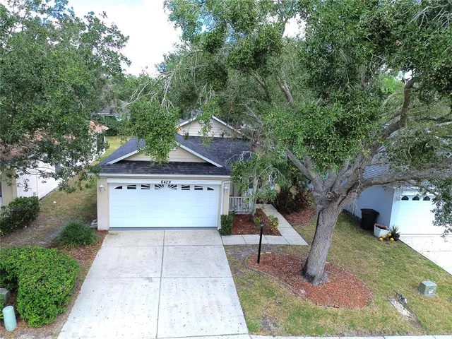 a view of house with outdoor space garden and tree