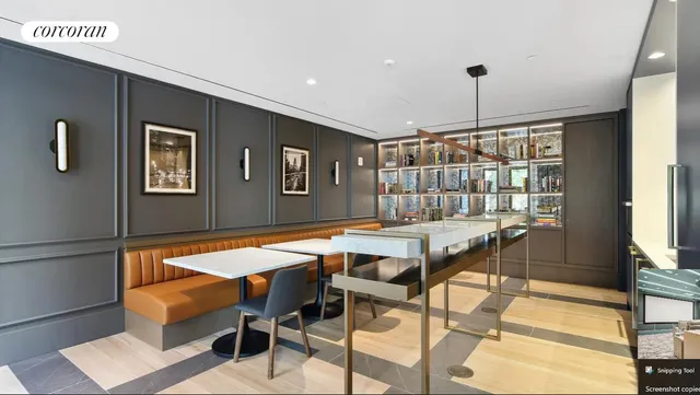 a dining hall with stainless steel appliances kitchen island granite countertop a table chairs in it and a wooden floor