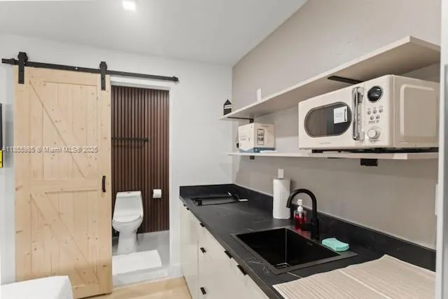 a kitchen with a sink and a refrigerator