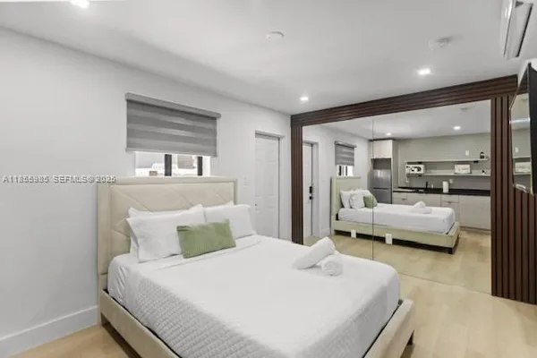 a bedroom with a large bed and a large window