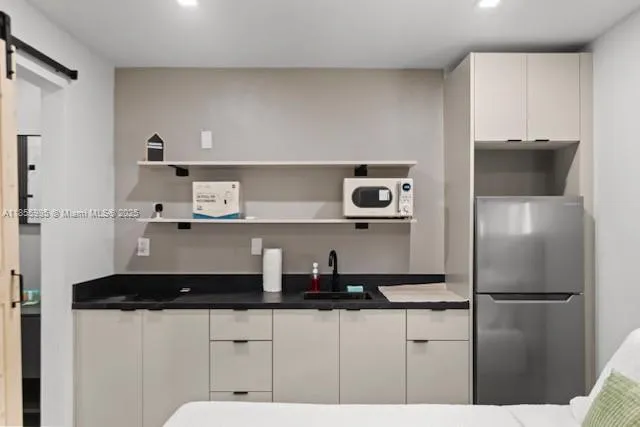 a kitchen with a refrigerator and a cabinets