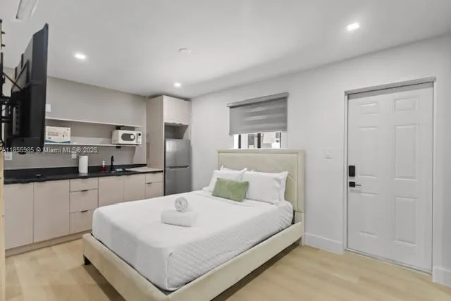 a large white bed in a white room