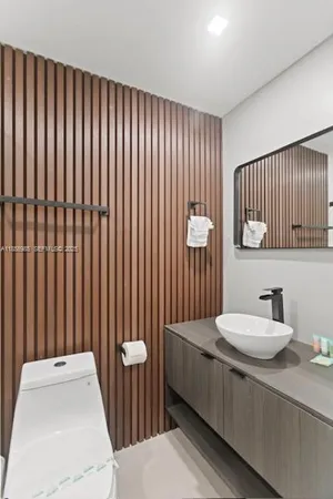 a bathroom with a sink toilet and mirror