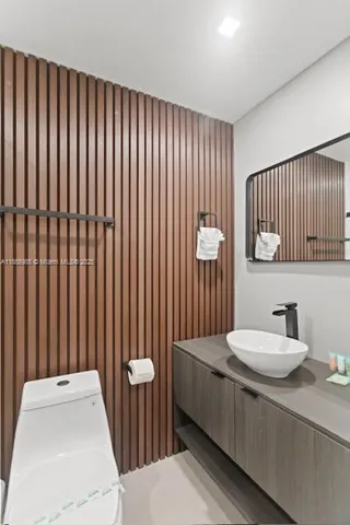 a bathroom with a sink a toilet and mirror