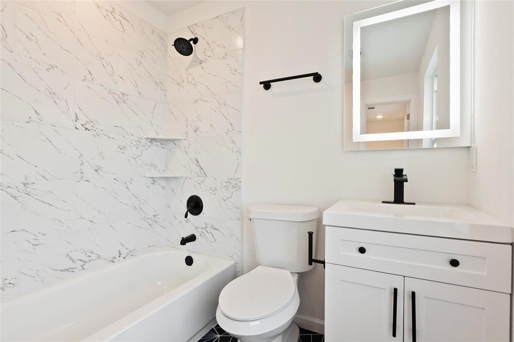310 Delmar Street, Unit C Houston, TX 77011 - Photo 10 of 11 a bathroom with a sink a toilet and a bathtub